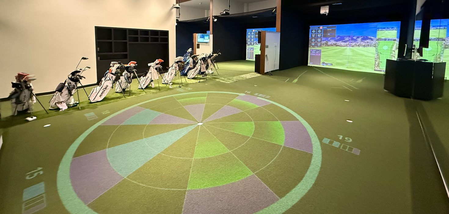 A target of coloured rings projected onto a putting green at a university golf facility
