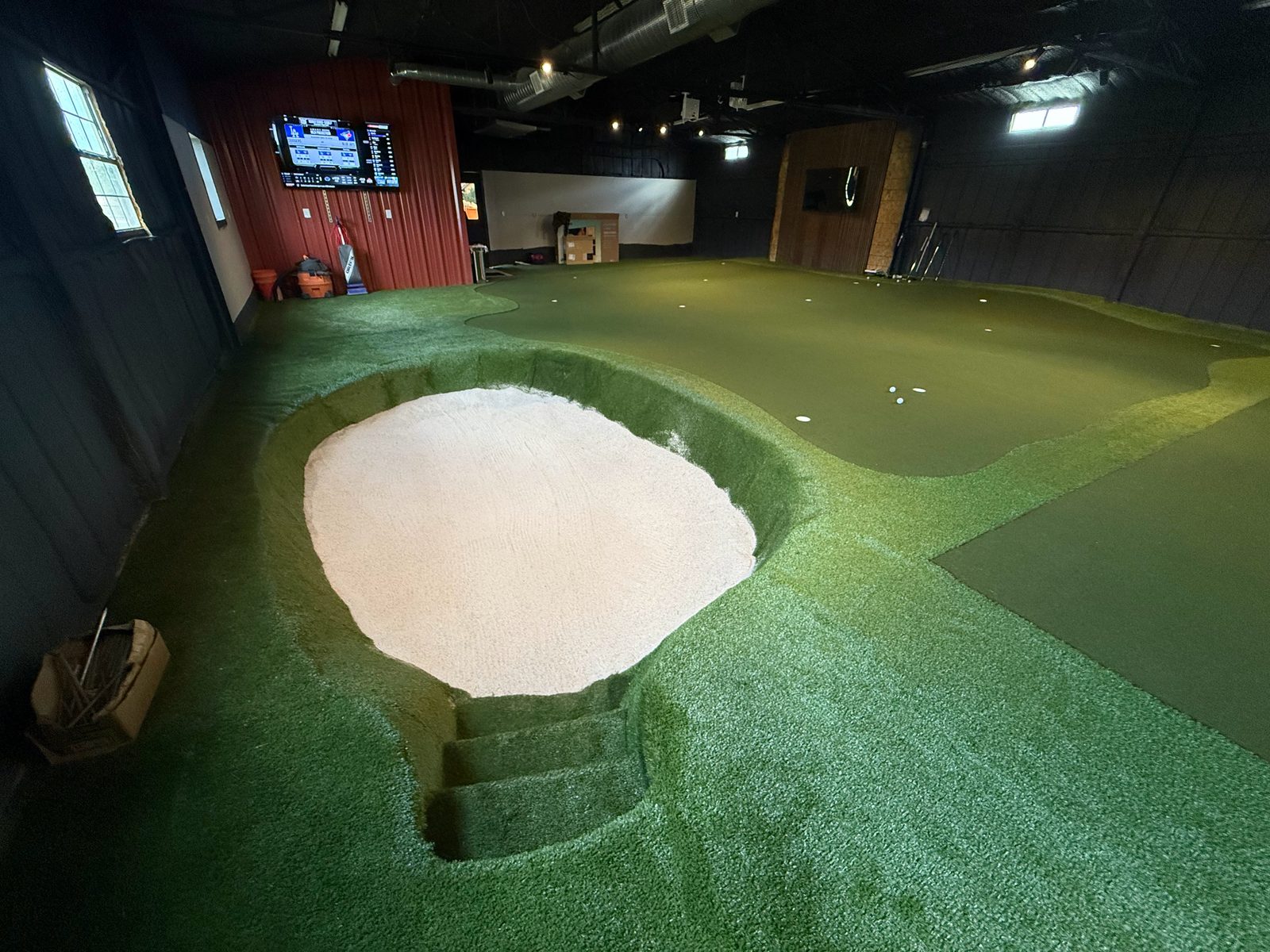 Texas Horse Ranch: an indoor putting green with a sand bunker